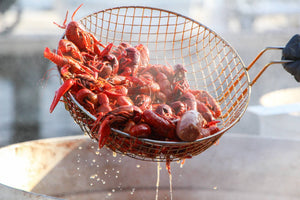 crawfish boil in a wire strainer