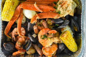 seafood boil leftovers in an aluminum container